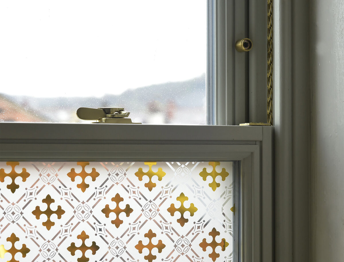 Slim sash window with gothic amber glass