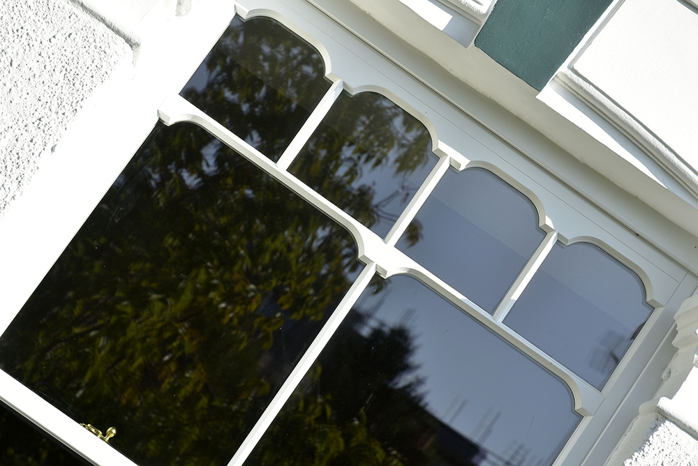 Slim sash windows finished in White with Tombstone design