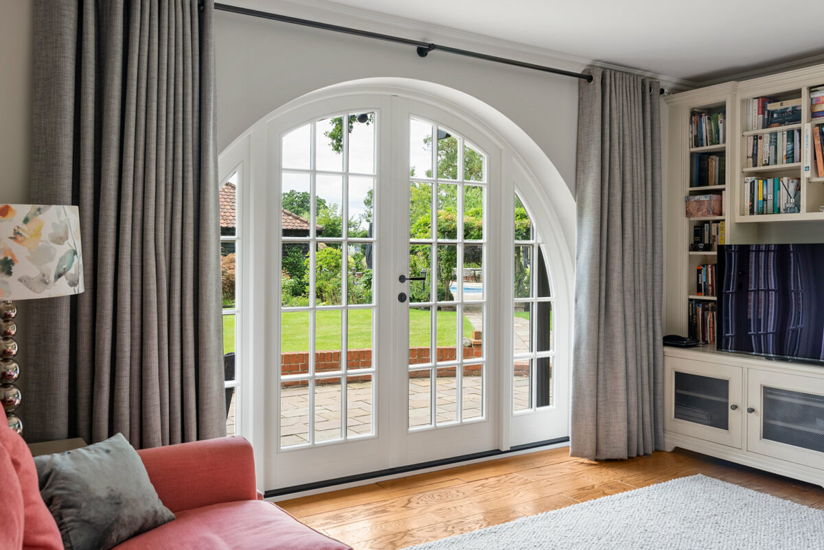 an arched set of french doors in a sitting room