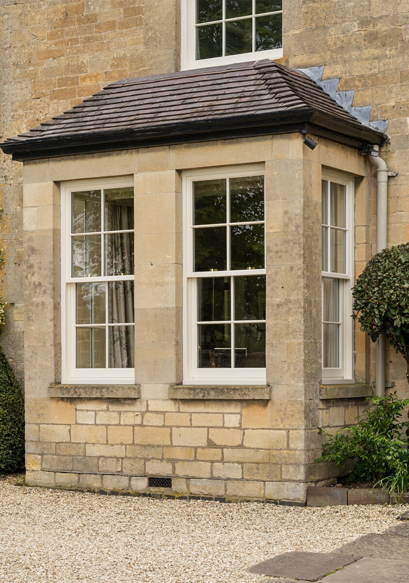 multiple sets of timber sash windows in a stone building