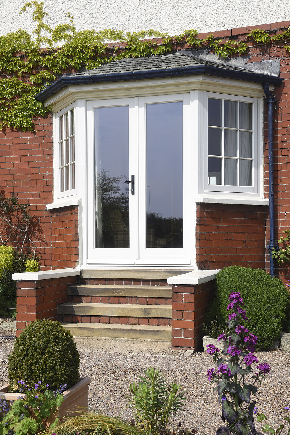Timber French doors finished in Cream with sidelights