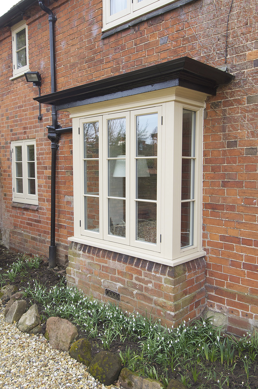 Bay window finished in Light Ivory manufactured in Engineered Redwood.