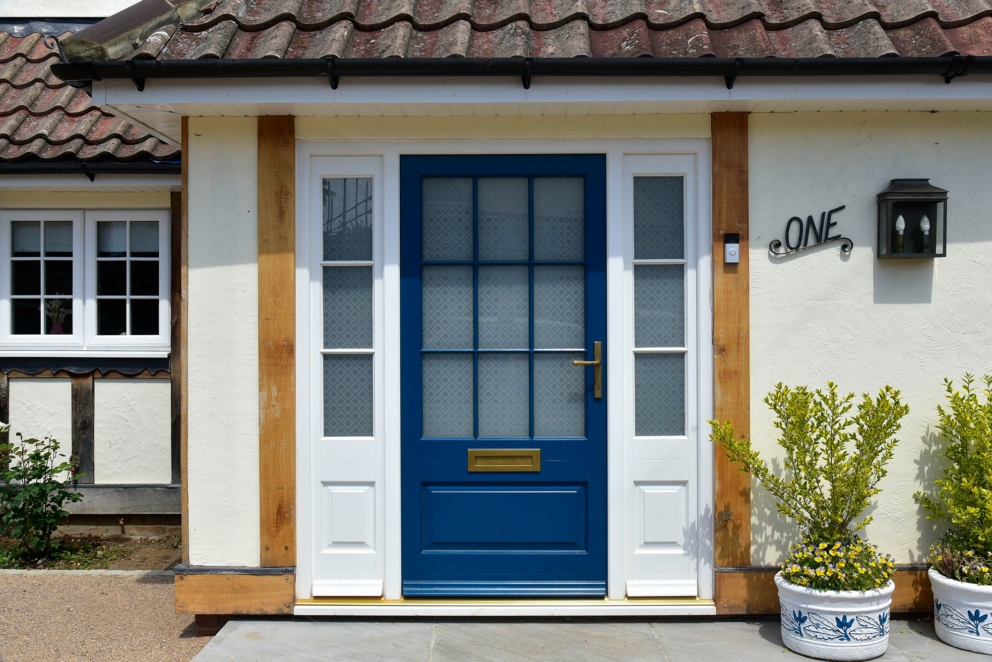 a blue front door with white sidelights