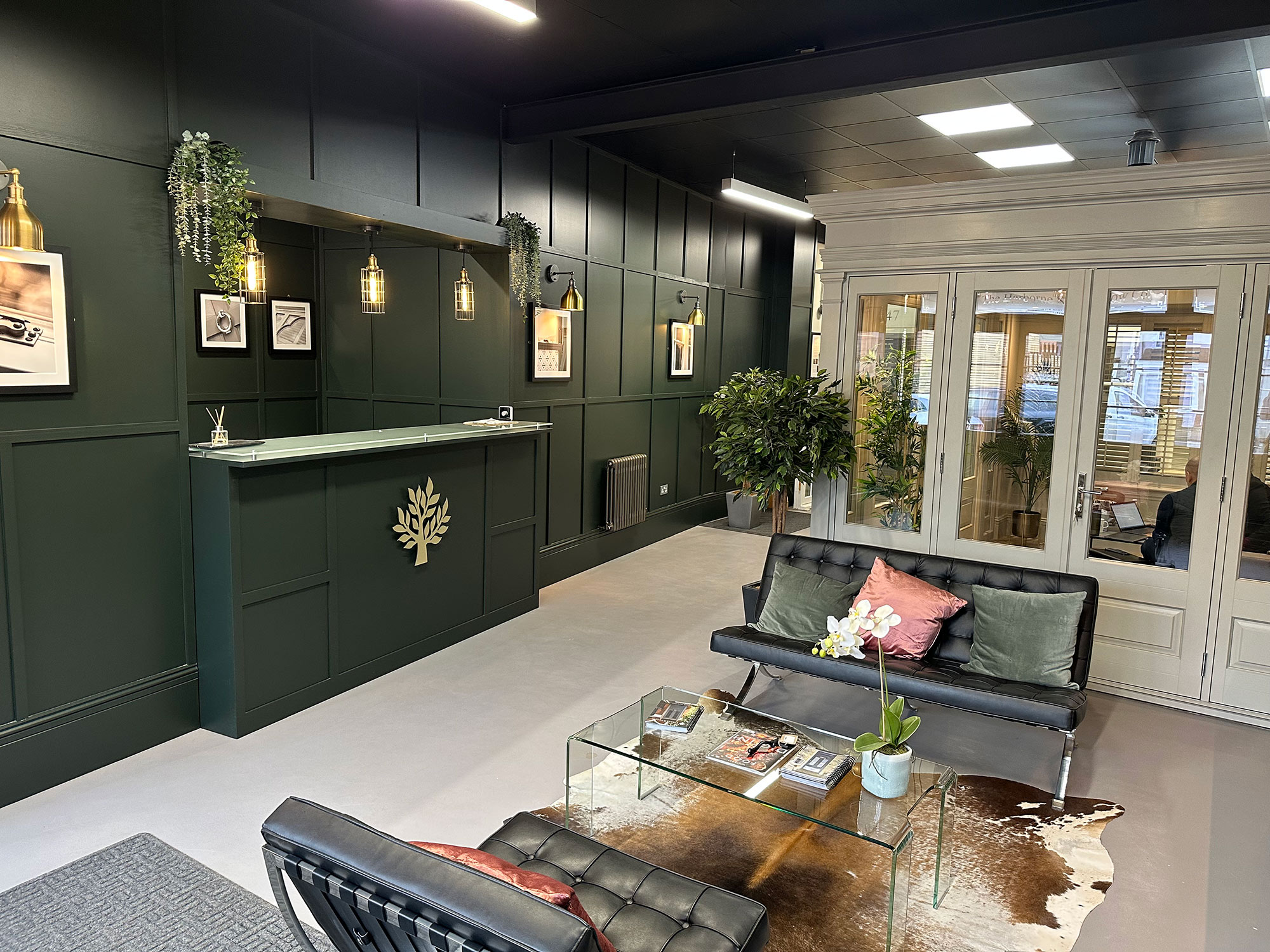 the inside of a timber doors showroom with green walls